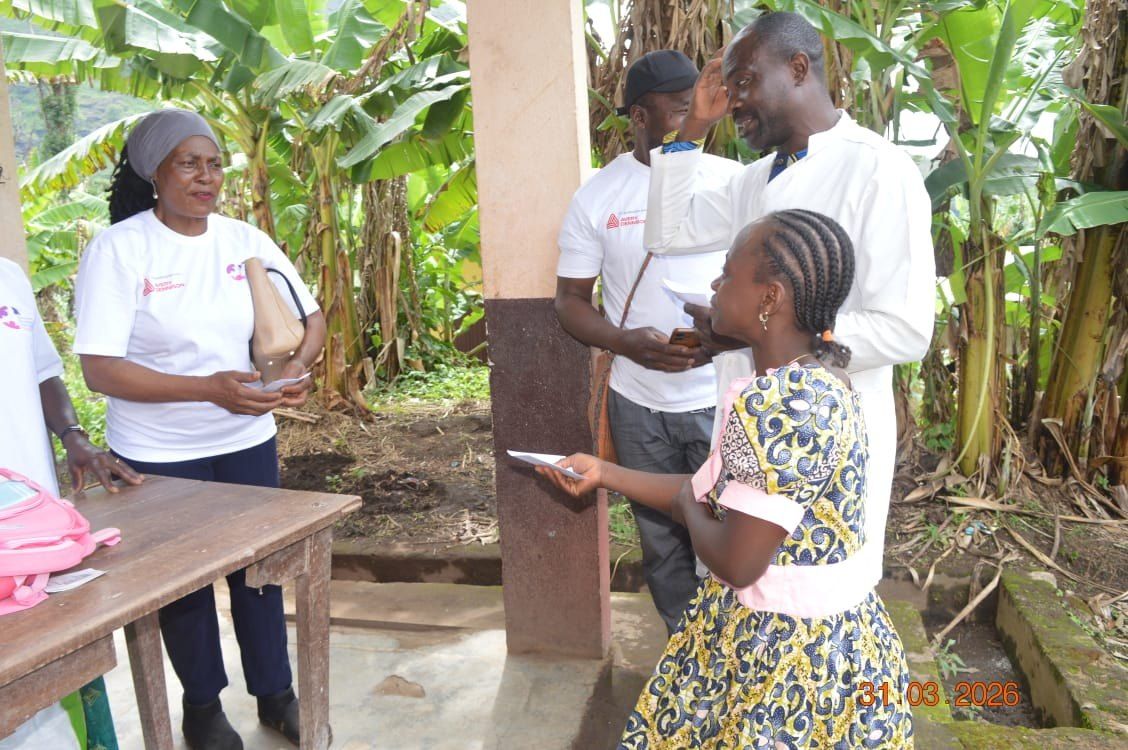 Remise d'un document à une jeune mère lors d'une opération de terrain
